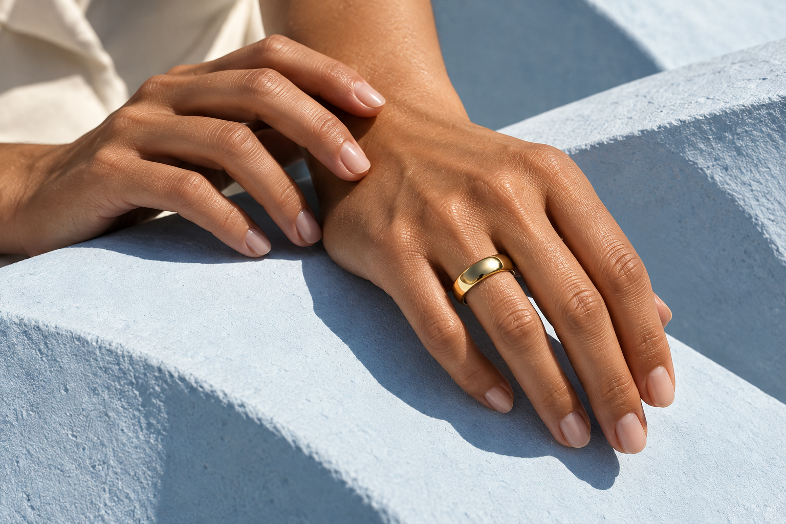 Jewelry styling inspiration: a polished gold-tone band in warm sunlight